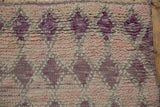 Textured pile with geometric diamond patterns in purple, mauve, and dusty rose abrashes.