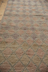 Distressed Moroccan runner's short pile, revealing pale rose, mauve, ivory diamond pattern.