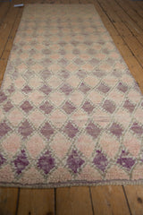 Textured pile shows pink, mauve, ivory diamond pattern with subtle color variations.