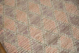 Distressed Moroccan runner pile, showing trellis and diamond motifs with abrashes in mauve, dusty rose.