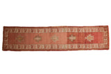 Distressed vintage Anatolian runner, dusty cochineal red, blush, ivory palmettes, serrated borders.