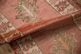 Rolled edge of distressed Anatolian runner, highlighting dusty red pile texture and abrash.