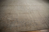 Close-up of distressed vintage Sparta carpet border, showing faded ivory and beige vinery.