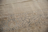 Distressed texture of the Sparta rug, highlighting muted ivory and silver floral vine details.