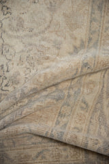 Distressed Sparta carpet texture showing worn pile and subtle ivory and beige tones.