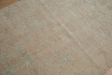 Evenly worn distressed Oushak rug pile, abrashed ivory and beige, with pale green floral buds.