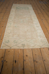 Distressed end of vintage Oushak runner, with pale dusty ocean green geometric border and fringe.