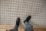 Distressed vintage Oushak runner with alternating beige and faded blue diamond patterns and textured pile.