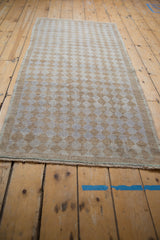 Distressed Oushak runner featuring alternating beige and pale blue diamond pattern.