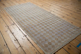 Distressed vintage Oushak runner detail showing alternating beige, pale mauve diamond pattern and worn selvage.