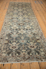 Distressed Malayer runner's worn pile, traditional palmettes and serrated leaves in slate, ivory, blue.