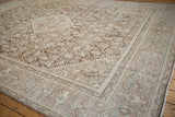 Distressed Mahal carpet close-up revealing Herati motif, worn pile, and muted coffee brown, ivory tones.