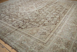 Distressed pile detail of vintage Mahal carpet with worn coffee brown and ivory Herati motifs.