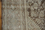 Distressed Mahal pile, worn Herati motif in dusty coffee brown, antique ivory, exposed foundation.