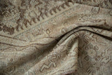 Distressed Mahal carpet's texture and visible wear in dusty brown and antique ivory.