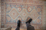 Vintage distressed Afshar rug texture with soft sky blue, ivory, and madder root shades.