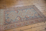 Distressed vintage Afshar rug corner detail, showing sky blue, madder, and ivory geometric floral motifs.