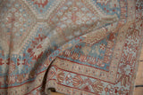 Distressed Afshar rug showing textured pile, muted sky blue, madder root, and ivory patterns.