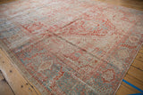 Faded cherry red, pale denim blue, and ivory tones on a distressed vintage Karaja carpet with visible pile wear.
