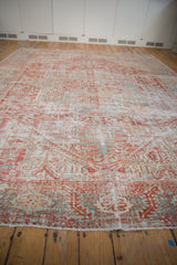 Distressed fringe with geometric patterns in faded red and pale blue on vintage Karaja rug.