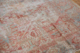 Distressed vintage Karaja rug texture revealing faded red, blue patterns, and foundation.