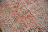 Distressed vintage Karaja carpet with faded cherry red and pale blue geometric patterns, visible wear to knot heads.
