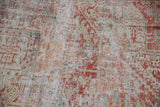 Distressed vintage Karaja carpet pile, revealing foundation, in faded cherry and pale blue.