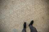 Faded floral palmettes and vinery on a distressed vintage Bijar rug with natural abrashes.