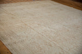 Distressed vintage Bijar rug showing soft beige tones, faded floral palmettes, and textured abrash.