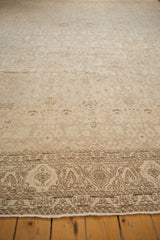 Distressed Bijar rug border showing faded floral palmettes, nuanced vinery, and fringe.