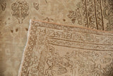 Distressed vintage Bijar carpet showing worn beige field, delicate floral patterns, geometric border, and reverse.