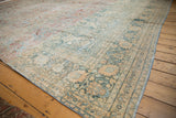 Faded powder blue, ivory, and blush palmette border of a vintage distressed Persian Khorassan rug.