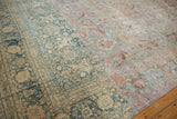 Distressed Khorassan carpet showing prominent dye lot change and worn palmette vinery.