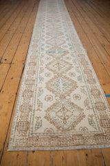 Distressed vintage runner featuring ivory, coffee brown, denim blue medallions and hook motifs.