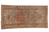Distressed vintage Borchalou rug, central Herati medallion, sky blue, rust, and beige tones.