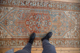 Distressed vintage Borchalou rug with sky blue Herati field, faded pile, and visible foundation.