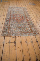 Distressed Borchalou rug corner with even wear to knot heads, faint foundation, blue and rust fringe.