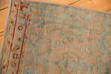 Evenly worn texture and cherry red floral border on a distressed vintage Sarouk runner.