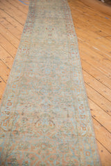 Full perspective view of the long vintage Sarouk runner with its distressed, allover floral pattern.