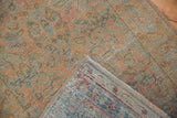 Corner of a distressed Persian Sarouk runner folded over to reveal the hand-knotted foundation.