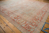 Distressed vintage Mahal carpet corner with faded pale cherry red and powder blue Herati patterns.