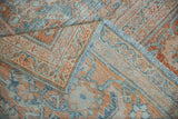 Distressed vintage Mahal rug pile, terracotta and powder blue Herati motif, visible foundation and fringe.