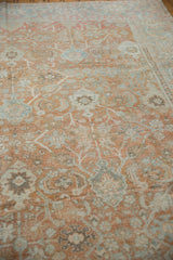 Distressed vintage Mahal rug texture showing terracotta, powder blue, and ivory Herati vinery.
