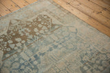 Distressed vintage Malayer rug detail with faded powder blue and coffee brown blossomed shrub motifs.