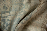 Close-up of the distressed Malayer rug's pile, revealing powder blue, ivory, and coffee brown details.