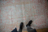 Overhead view showing the worn texture of a fine Mahal rug in seafoam and terracotta.