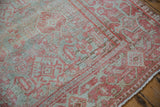 Angled detail showing the vintage Mahal rug's worn pile and Samovar border.