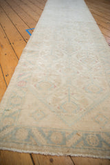 Distressed vintage Malayer runner showing even pile wear and ivory, powder blue geometric pattern.