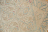 Distressed Malayer runner detail: softened ivory, powder blue lattice, and worn pile.