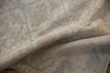 Close-up of distressed Malayer runner pile, showing softened ivory and powder blue hues.